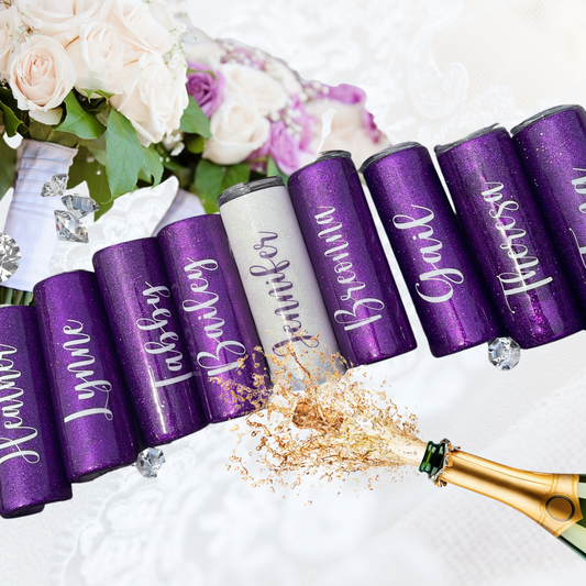 A champagne bottle popping, bouquet of flowers and bridal party tumblers.