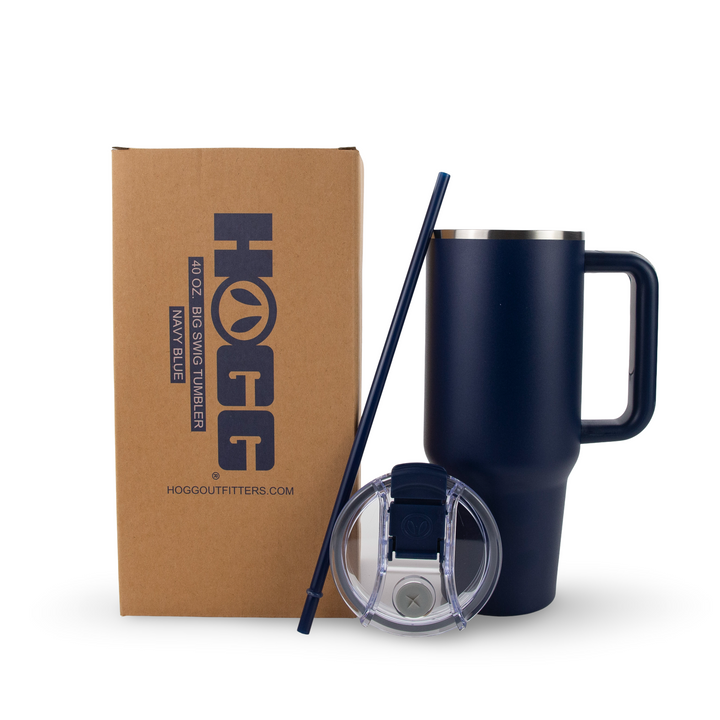 Navy blue tumbler with straw and lid next to a cardboard box with HOGG branding.