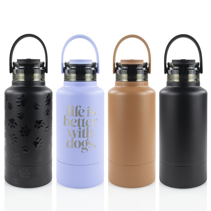 A collection of four powder coated hydro hound tumblers in black, lavender, tan, and black with accents, each featuring a handle and a screw-on lid.